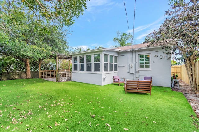 305 Vanderbilt Dr, Lake Worth Beach, FL 33460 - rear view of house with stucco siding and outdoor lounge area