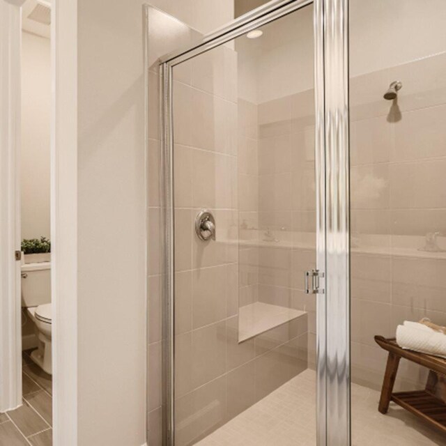 13809 Hero Path, Delray Beach, FL 33484 - bathroom with toilet, a shower stall, and tile patterned floors
