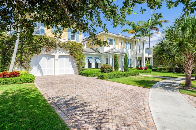 110 Sea Ln, Delray Beach, FL 33483 - view of front facade featuring decorative driveway, an attached garage, and a front lawn