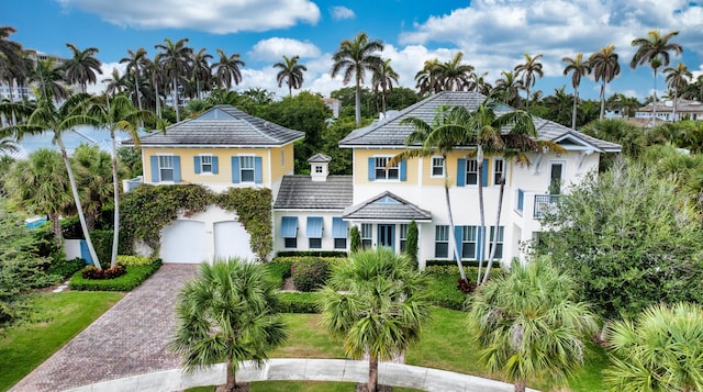 110 Sea Ln, Delray Beach, FL 33483 - view of front facade with decorative driveway, an attached garage, and stucco siding