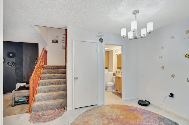 6644 66th Way, West Palm Beach, FL 33409 - staircase with a textured ceiling, a chandelier, tile patterned floors, and baseboards
