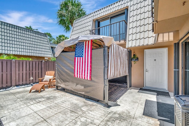 6644 66th Way, West Palm Beach, FL 33409 - property entrance featuring a patio area and a tiled roof