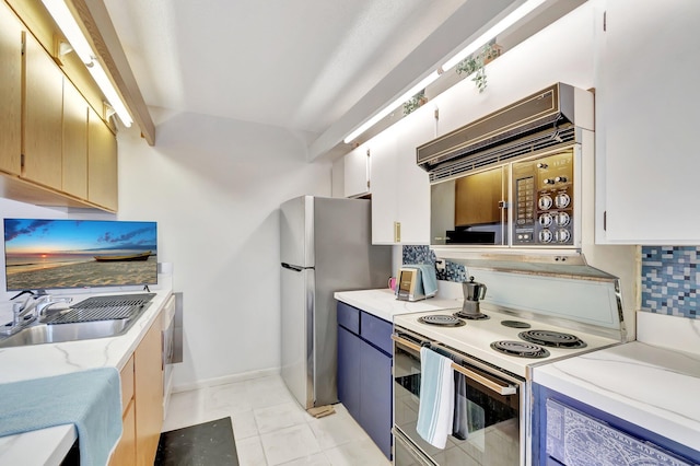 6644 66th Way, West Palm Beach, FL 33409 - kitchen with white electric range, a sink, freestanding refrigerator, light stone countertops, and baseboards