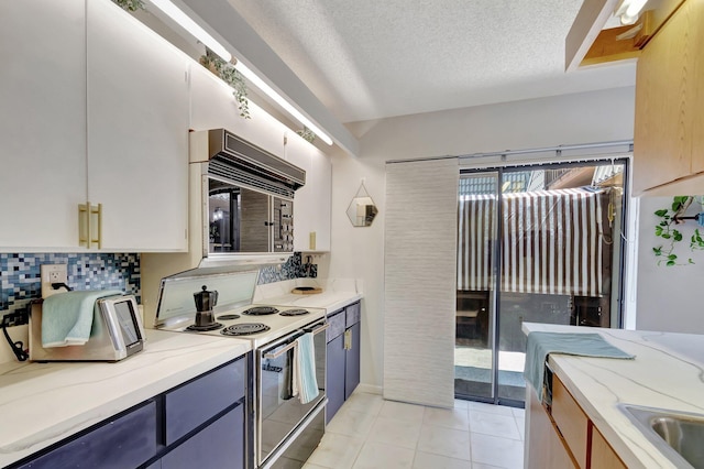 6644 66th Way, West Palm Beach, FL 33409 - kitchen featuring electric range, light stone countertops, black microwave, light tile patterned floors, and decorative backsplash