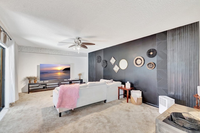 6644 66th Way, West Palm Beach, FL 33409 - carpeted living area with a ceiling fan, a textured ceiling, and an accent wall