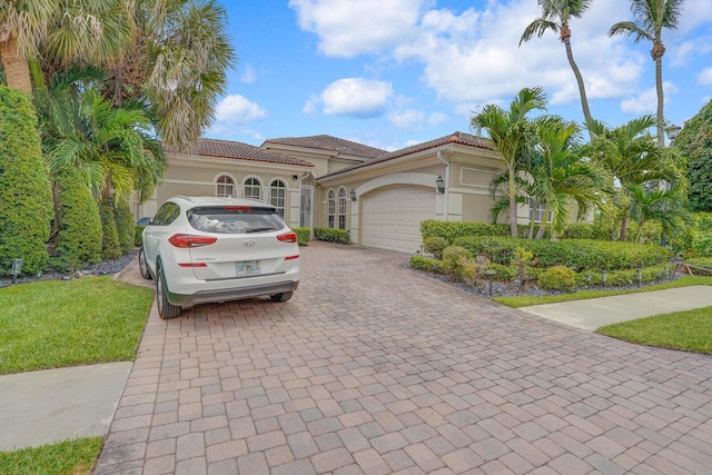 6468 Polo Pointe Way, Delray Beach, FL 33484 - mediterranean / spanish house with decorative driveway, an attached garage, stucco siding, a tiled roof, and a front yard