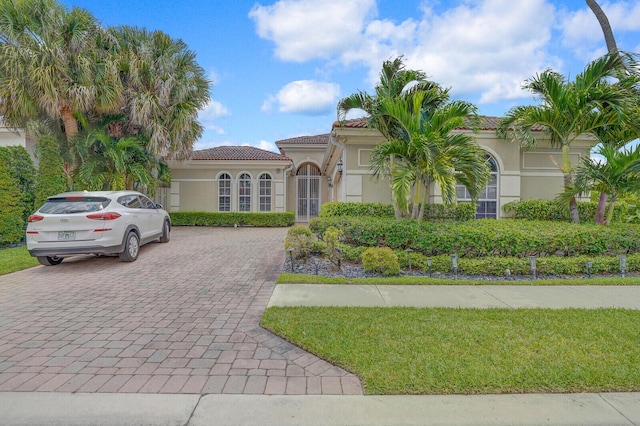 6468 Polo Pointe Way, Delray Beach, FL 33484 - mediterranean / spanish-style home featuring stucco siding, a tiled roof, and driveway