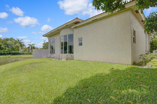 6468 Polo Pointe Way, Delray Beach, FL 33484 - rear view of property with stucco siding, a yard, and a water view