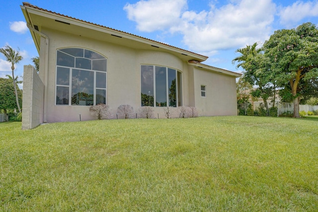 6468 Polo Pointe Way, Delray Beach, FL 33484 - view of side of property with stucco siding, a lawn, and a tile roof