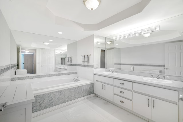 16711 Collins Ave Unit 1906, Sunny Isles Beach, FL 33160 - bathroom featuring double vanity, a tray ceiling, a bath, and recessed lighting