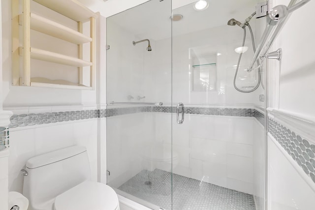 16711 Collins Ave Unit 1906, Sunny Isles Beach, FL 33160 - bathroom featuring toilet, a shower stall, and tile walls