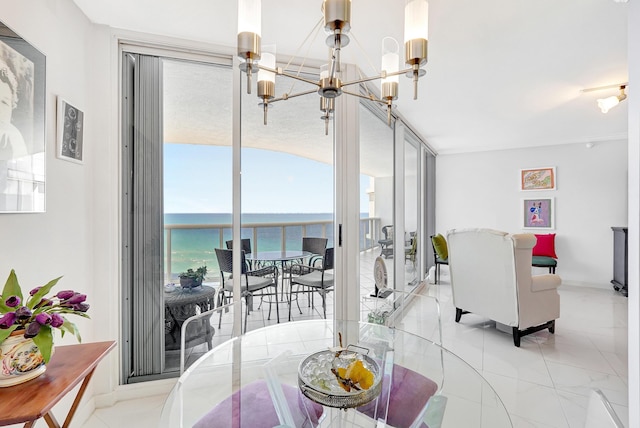 16711 Collins Ave Unit 1906, Sunny Isles Beach, FL 33160 - dining room with a chandelier, a water view, and baseboards