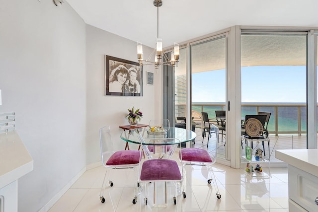 16711 Collins Ave Unit 1906, Sunny Isles Beach, FL 33160 - dining space featuring a chandelier, light tile patterned floors, a water view, baseboards, and a wall of windows