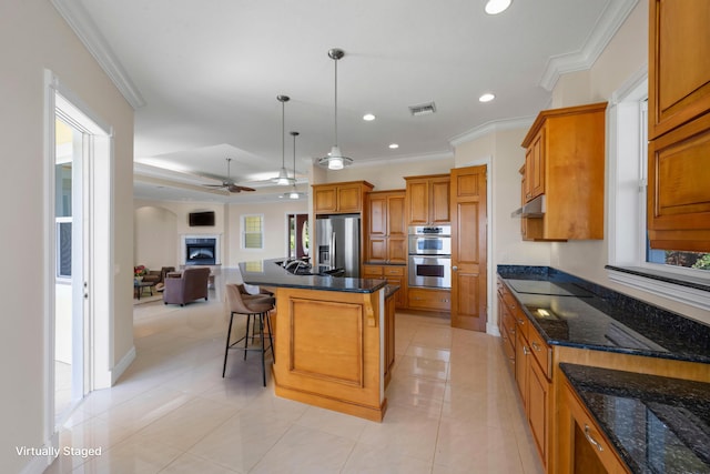 1530 NE Dixie Hwy, Jensen Beach, FL 34957 - kitchen with appliances with stainless steel finishes, open floor plan, brown cabinets, under cabinet range hood, and a ceiling fan