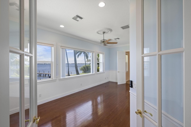 1530 NE Dixie Hwy, Jensen Beach, FL 34957 - unfurnished room with ornamental molding, dark wood-type flooring, a water view, baseboards, and recessed lighting