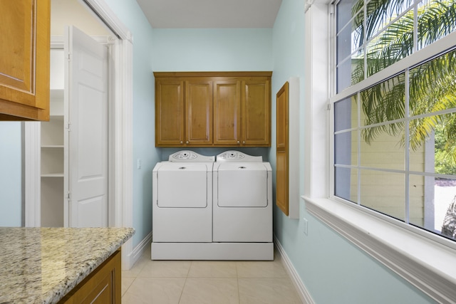 1530 NE Dixie Hwy, Jensen Beach, FL 34957 - washroom with cabinet space, baseboards, separate washer and dryer, and plenty of natural light
