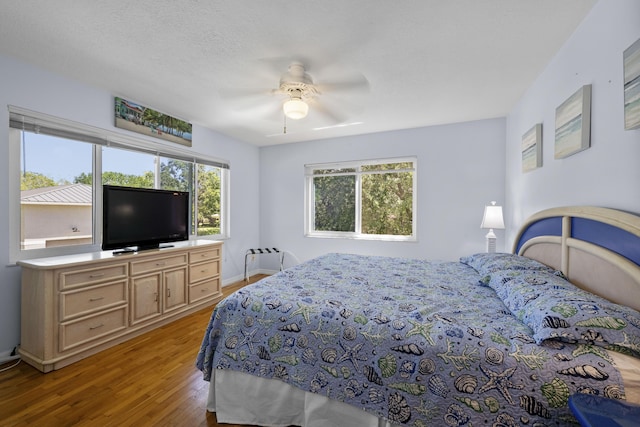 1530 NE Dixie Hwy, Jensen Beach, FL 34957 - bedroom with light wood-style floors, ceiling fan, and baseboards
