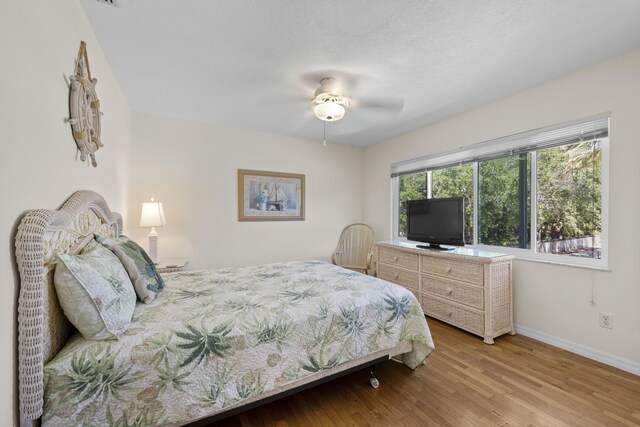 1530 NE Dixie Hwy, Jensen Beach, FL 34957 - bedroom with baseboards, wood finished floors, and ceiling fan