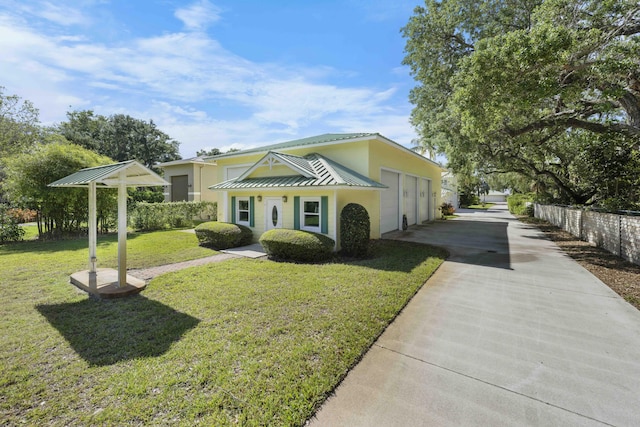 1530 NE Dixie Hwy, Jensen Beach, FL 34957 - view of front of property featuring driveway, stucco siding, a front lawn, a garage, and metal roof