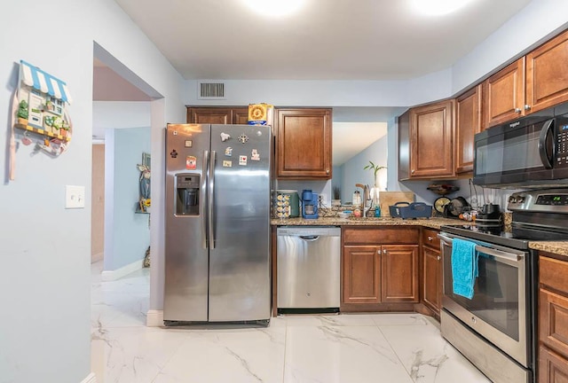14747 Cumberland Dr Unit 1010, Delray Beach, FL 33446 - kitchen featuring stainless steel appliances, light marble finish flooring, brown cabinets, and a sink