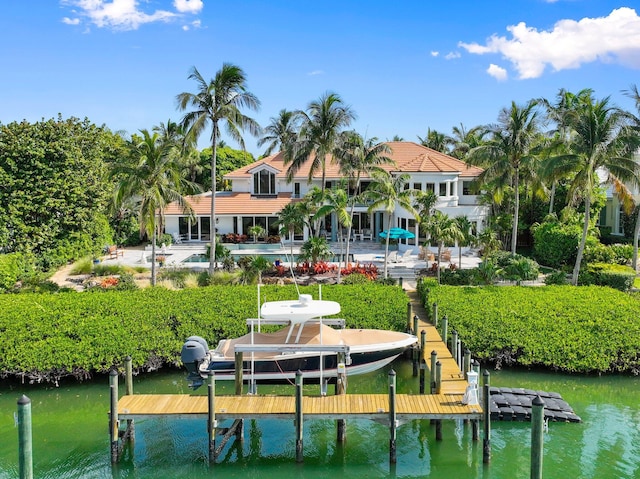 6460 SE Harbor Cir, Stuart, FL 34996 - dock area featuring boat lift, a water view, and a pool