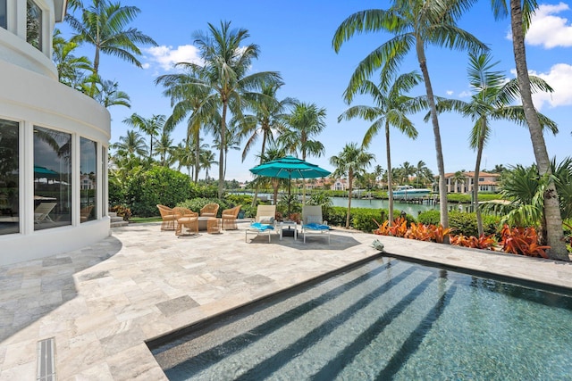 6460 SE Harbor Cir, Stuart, FL 34996 - swimming pool with a patio, a water view, and outdoor lounge area