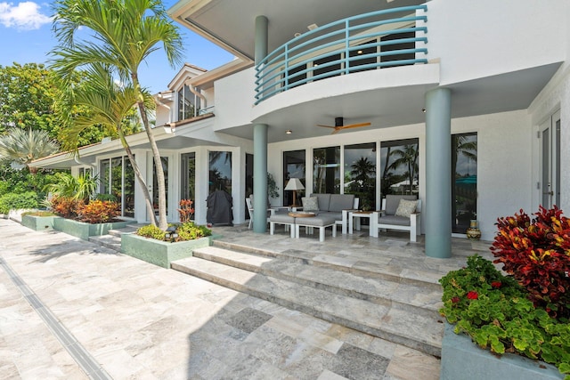 6460 SE Harbor Cir, Stuart, FL 34996 - back of property featuring a balcony, an outdoor living space, a patio, ceiling fan, and stucco siding