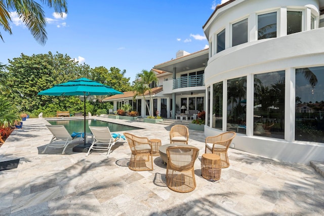 6460 SE Harbor Cir, Stuart, FL 34996 - view of patio / terrace featuring an outdoor pool and a balcony
