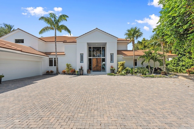 6460 SE Harbor Cir, Stuart, FL 34996 - view of front of house featuring a tile roof, decorative driveway, and stucco siding