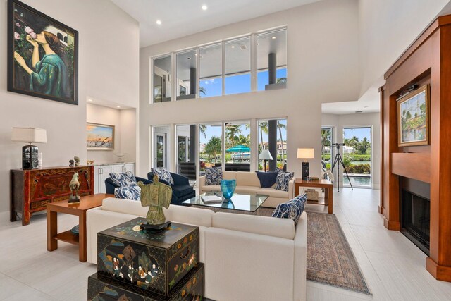 6460 SE Harbor Cir, Stuart, FL 34996 - living room featuring a fireplace, recessed lighting, and a towering ceiling
