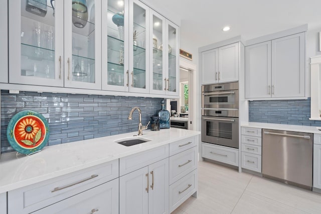 6460 SE Harbor Cir, Stuart, FL 34996 - kitchen with appliances with stainless steel finishes, a sink, backsplash, recessed lighting, and light tile patterned floors