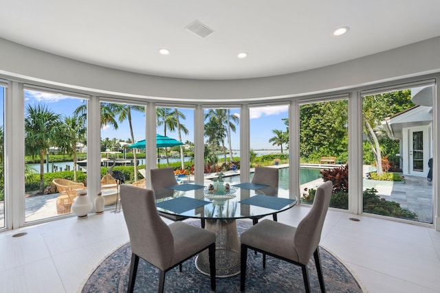 6460 SE Harbor Cir, Stuart, FL 34996 - dining area featuring a water view, recessed lighting, and healthy amount of natural light