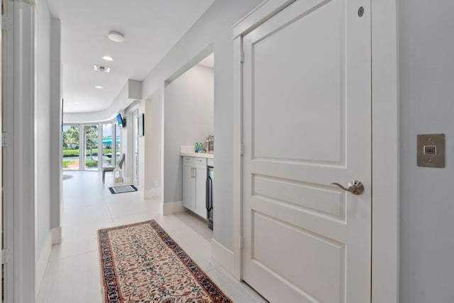 6460 SE Harbor Cir, Stuart, FL 34996 - hall with baseboards, light tile patterned floors, and recessed lighting