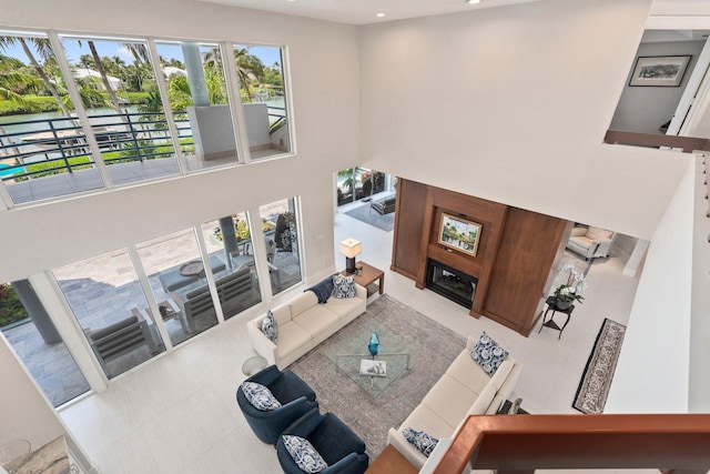 6460 SE Harbor Cir, Stuart, FL 34996 - living area featuring recessed lighting, a high ceiling, light tile patterned floors, and a water view