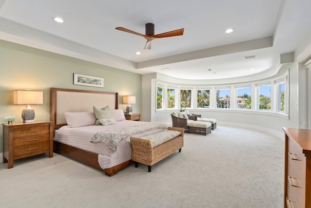 6460 SE Harbor Cir, Stuart, FL 34996 - bedroom with light colored carpet, multiple windows, recessed lighting, ceiling fan, and a raised ceiling
