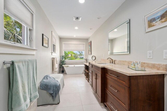 6460 SE Harbor Cir, Stuart, FL 34996 - bathroom with vanity, tile patterned floors, a freestanding tub, and recessed lighting