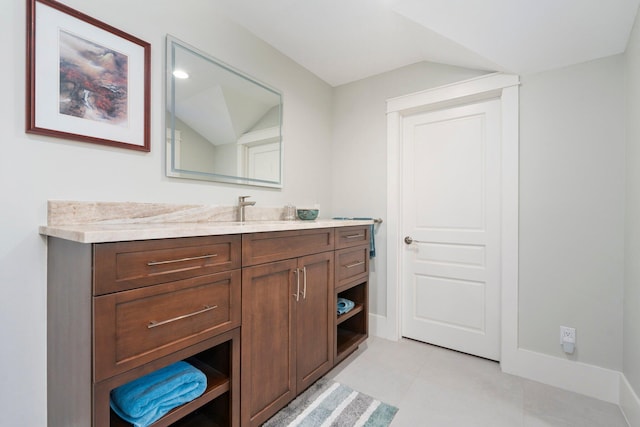 6460 SE Harbor Cir, Stuart, FL 34996 - bathroom with lofted ceiling, vanity, tile patterned floors, and baseboards