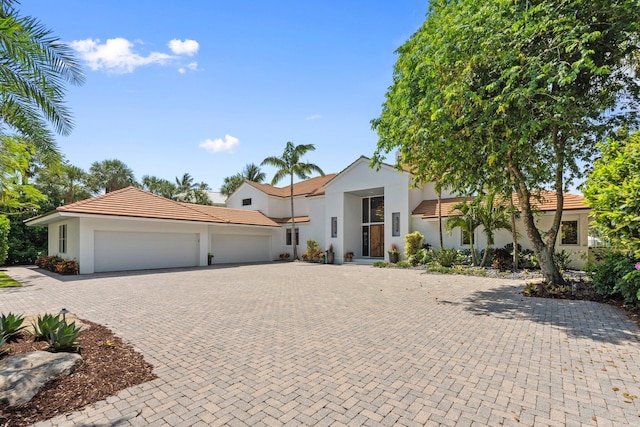 6460 SE Harbor Cir, Stuart, FL 34996 - view of front facade with a garage, decorative driveway, a tile roof, and stucco siding