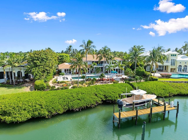 6460 SE Harbor Cir, Stuart, FL 34996 - dock featuring boat lift, a water view, and an outdoor pool