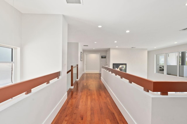 6460 SE Harbor Cir, Stuart, FL 34996 - hallway featuring an upstairs landing, wood finished floors, recessed lighting, and baseboards