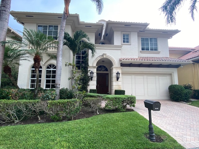 3628 S Ocean Blvd, Highland Beach, FL 33487 - mediterranean / spanish house with decorative driveway, stucco siding, a garage, a tiled roof, and a front lawn