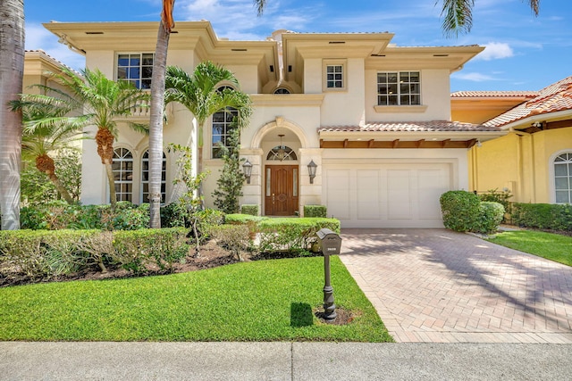 3628 S Ocean Blvd, Highland Beach, FL 33487 - mediterranean / spanish house with stucco siding, decorative driveway, a front yard, and a tiled roof