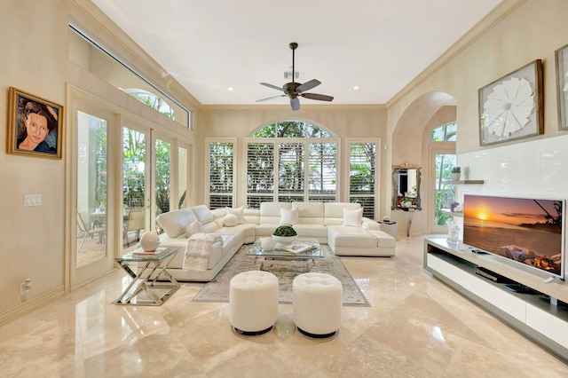 3628 S Ocean Blvd, Highland Beach, FL 33487 - living area with marble tiled floors, a ceiling fan, ornamental molding, arched walkways, and baseboards