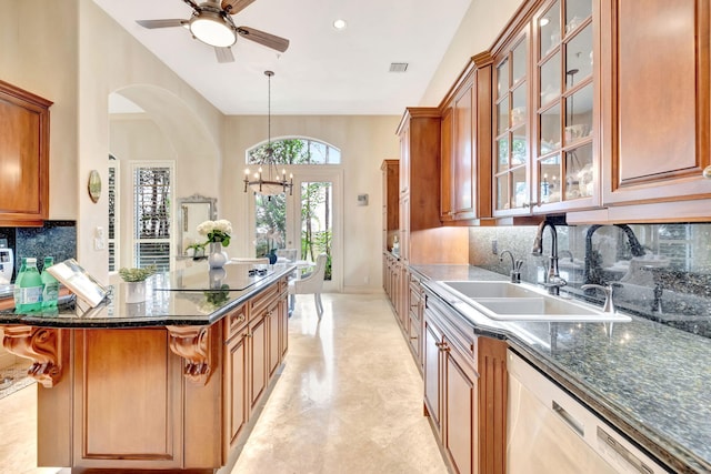 3628 S Ocean Blvd, Highland Beach, FL 33487 - kitchen featuring a sink, dishwasher, a chandelier, brown cabinets, and backsplash