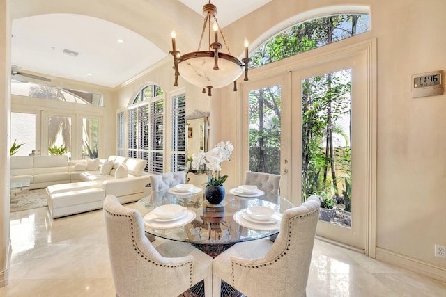 3628 S Ocean Blvd, Highland Beach, FL 33487 - dining room with light marble finish floors, a chandelier, and french doors