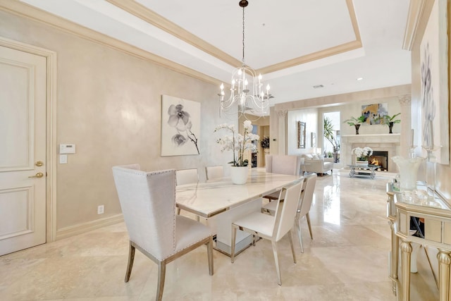 3628 S Ocean Blvd, Highland Beach, FL 33487 - dining space with a chandelier, a tray ceiling, a fireplace, and crown molding