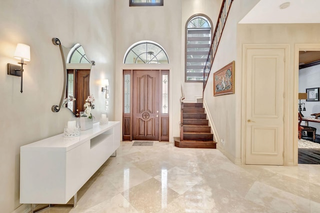 3628 S Ocean Blvd, Highland Beach, FL 33487 - entrance foyer with stairs, light marble finish floors, healthy amount of natural light, and a high ceiling