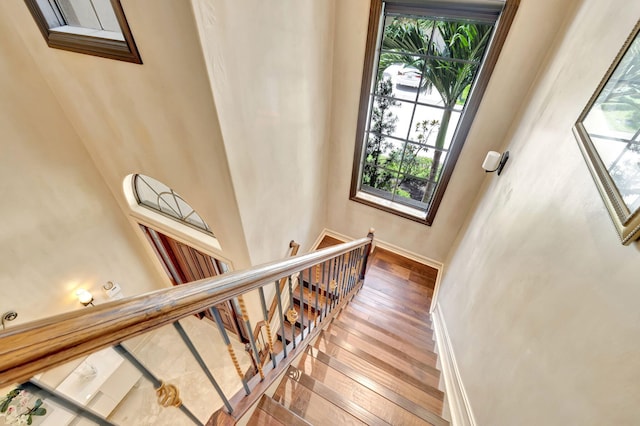 3628 S Ocean Blvd, Highland Beach, FL 33487 - stairway featuring healthy amount of natural light, hardwood / wood-style flooring, and baseboards