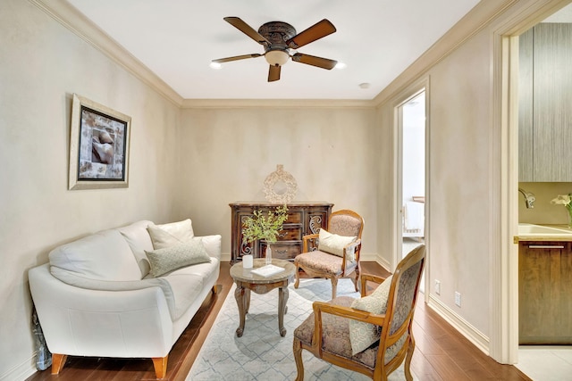 3628 S Ocean Blvd, Highland Beach, FL 33487 - living area featuring wood finished floors, a ceiling fan, ornamental molding, and baseboards