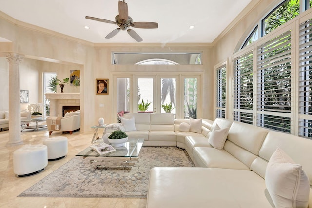 3628 S Ocean Blvd, Highland Beach, FL 33487 - living room featuring ornamental molding, healthy amount of natural light, a ceiling fan, and a warm lit fireplace